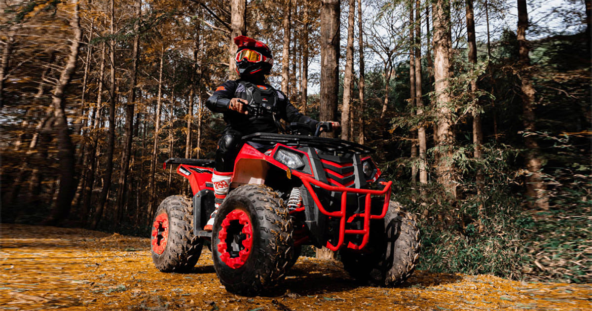 A rider riding a sport ATV in outdoor trails