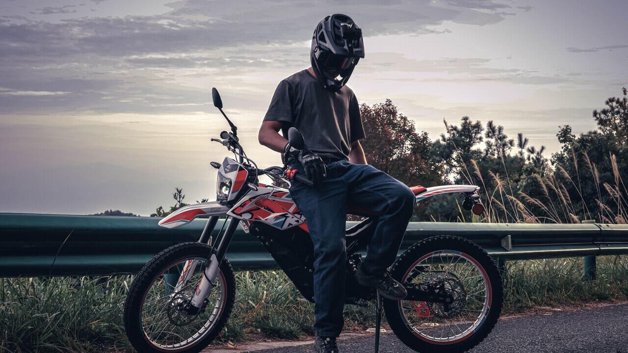 A rider leaning on his new dirt bike